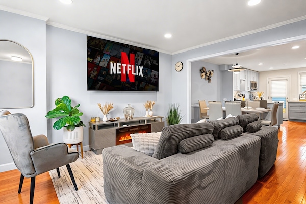 Spacious main living room with plush seating, Samsung 8K 85” smart TV,