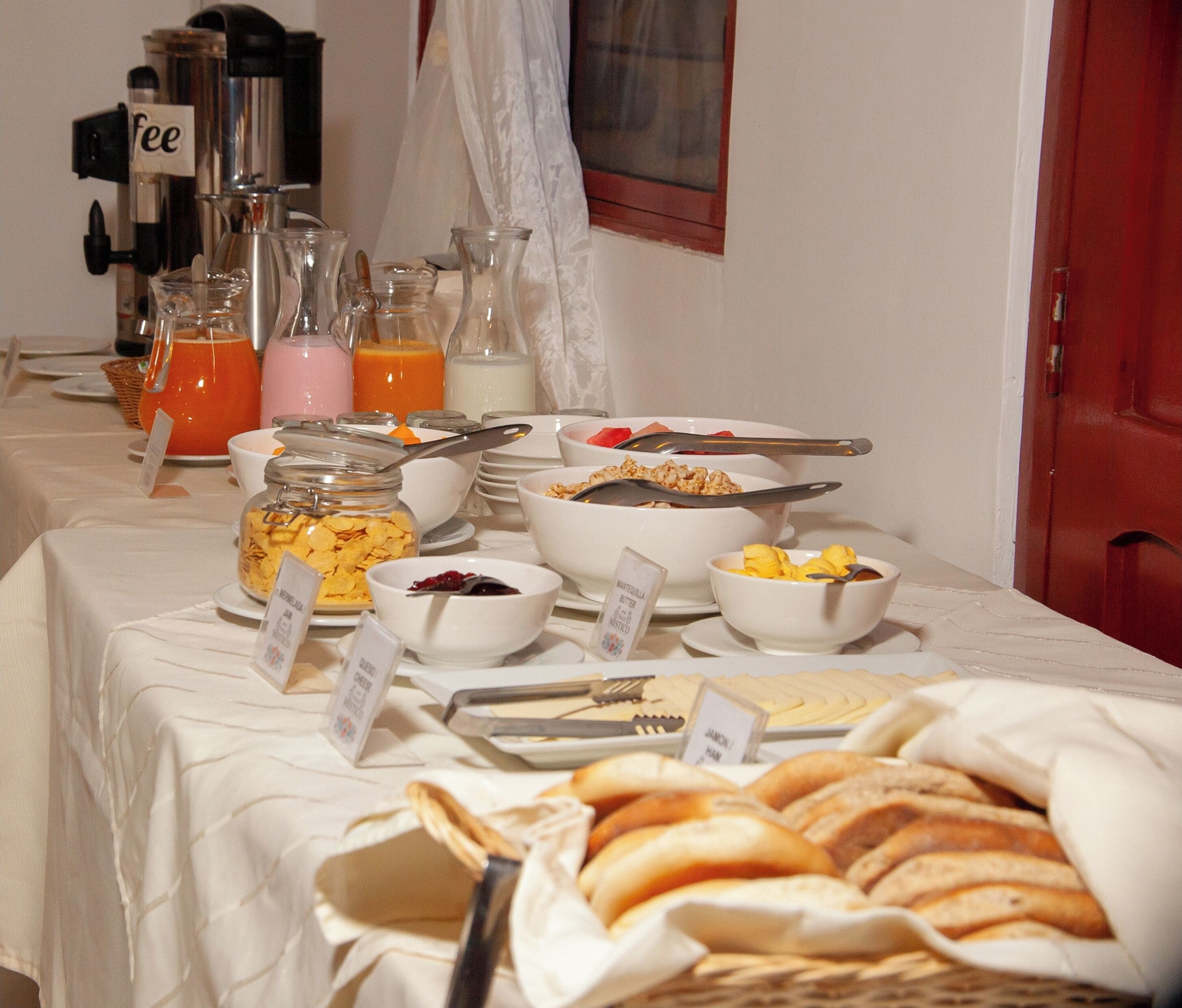A breakfast buffet with various food items and a coffee station.