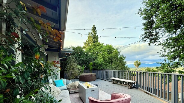 A deck with outdoor furniture, a view of the landscape, and string lights. - Charming bungalow house in Sherman Oaks w/ pool table, fire pit, hot tub & piano (Los Angeles)