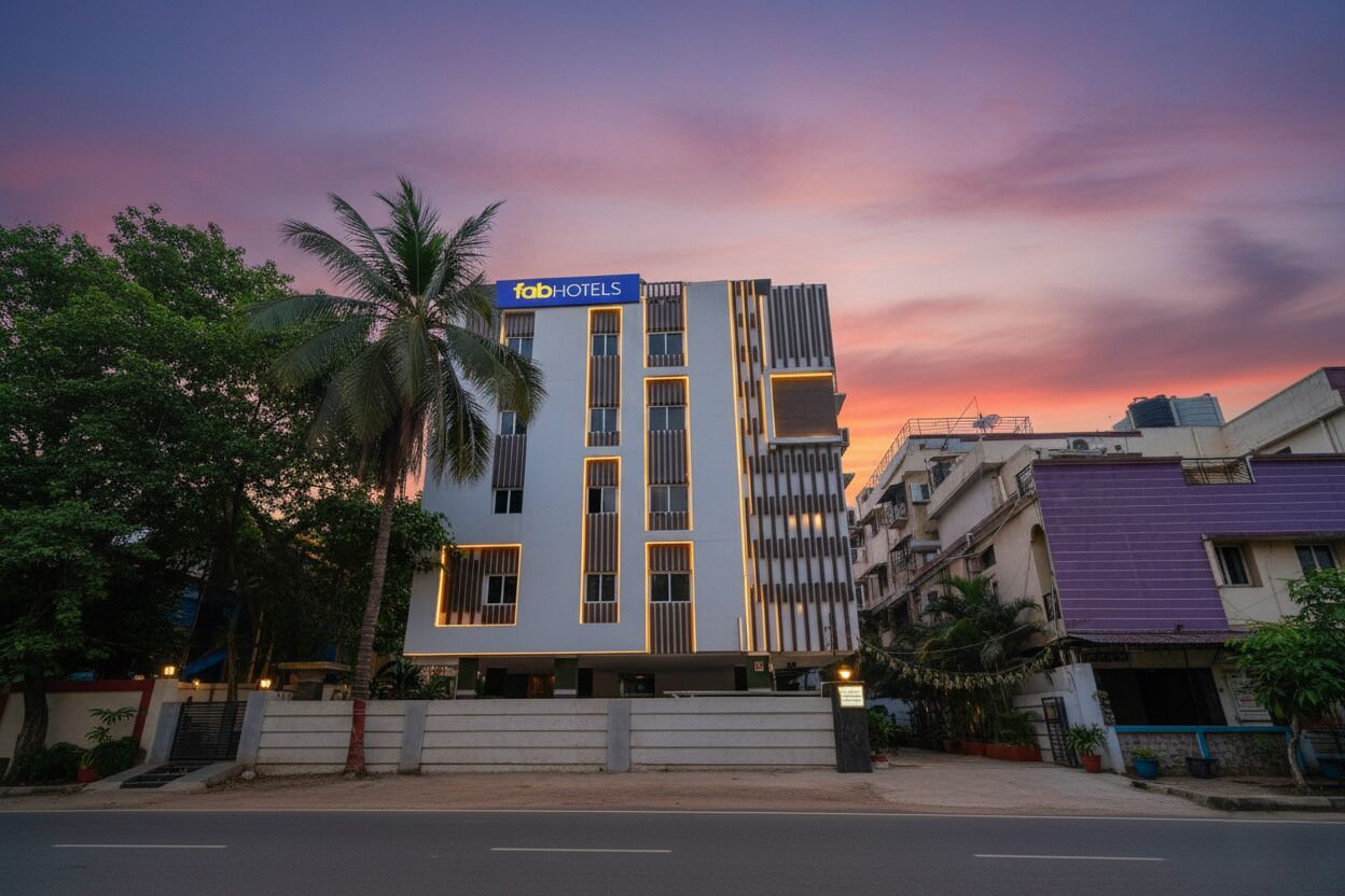 A modern hotel with a flat roof, a signboard, and a well-maintained facade.