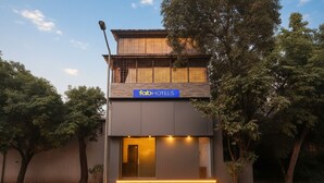 A modern building with a 'faabHOTELS' sign, featuring a flat facade, large windows, and a well-lit entrance. - FabHotel Millenium (Mumbai)