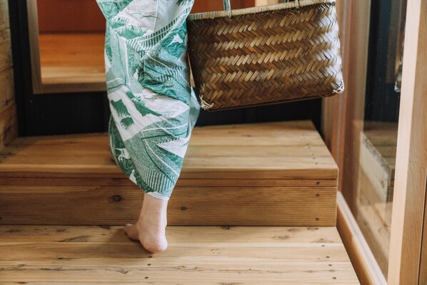 A wooden staircase with a woven basket. - Wafu Onsen Motoyu Kano (Himi)