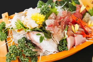 A wooden platter with various seafood and vegetables.