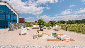 An outdoor patio with seating, a table, and a decorative lantern.