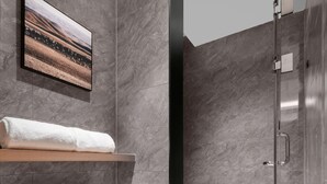 A modern bathroom with a toilet, a shower, and a mounted picture. - Meilun Hotel Xian Qujiang Convention Center Mixc (Xi'an)