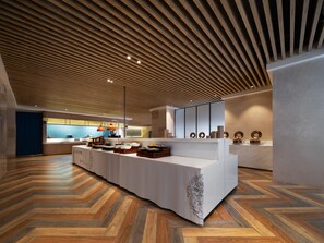 Una cocina moderna con una encimera larga, techo de madera y un suelo con diseño de espiga.