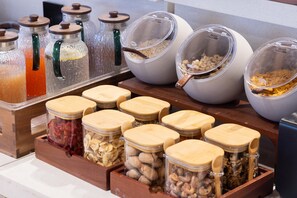 A breakfast buffet with various food items in glass containers and bowls. - Meilun Hotel Xian Qujiang Convention Center Mixc (Xi'an)