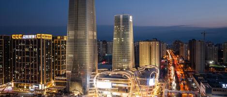 A modern cityscape with high-rise buildings and a well-lit urban area.
