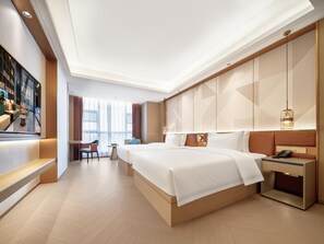A modern hotel room with a large bed, a desk, and a seating area with a view of the city. - Madison Hotel Wuxi Luocheng (Wuxi)