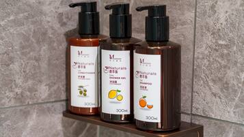 Three bottles of hair care products on a shelf.