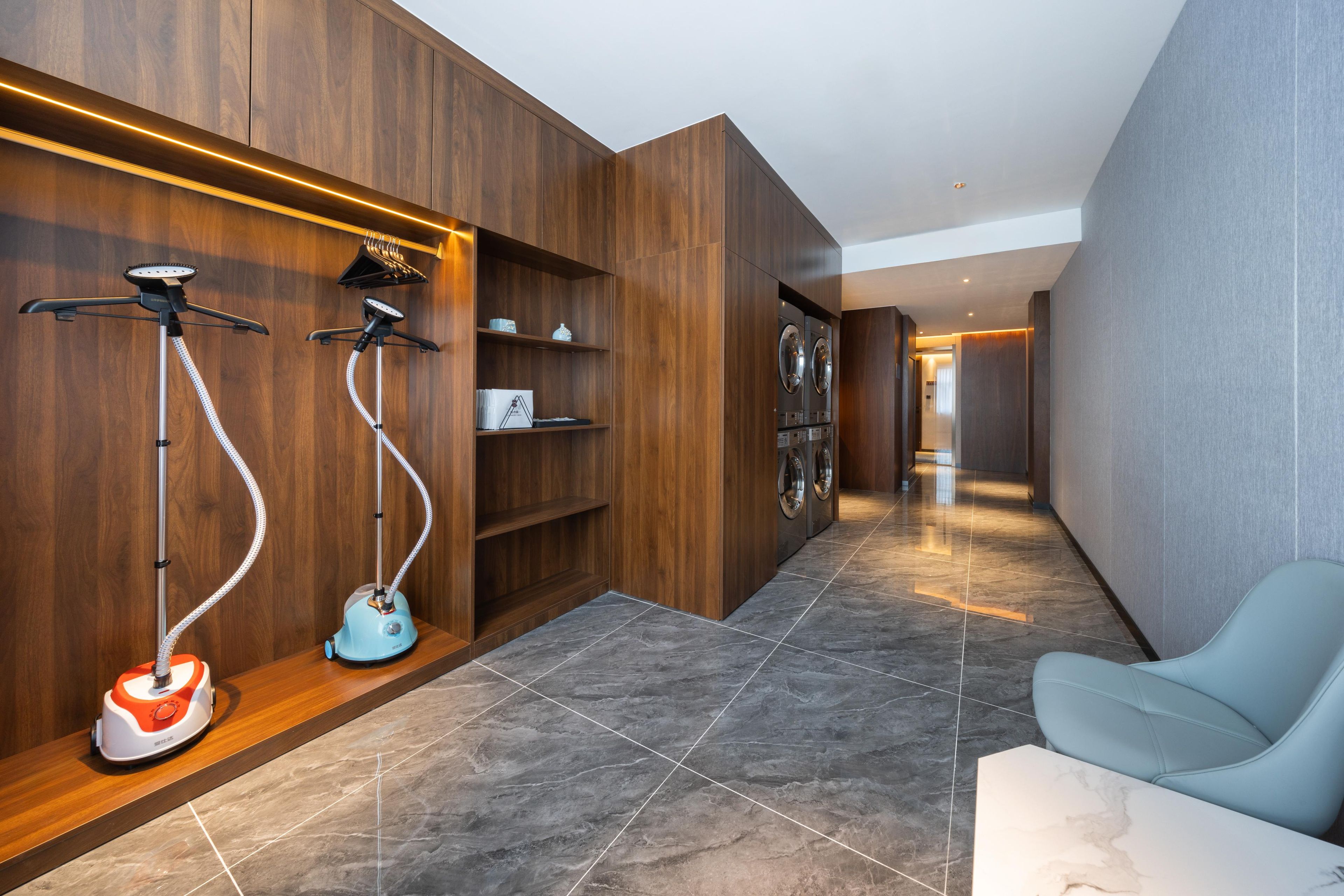 A modern bathroom with a wooden vanity, a sink, and a mirror.