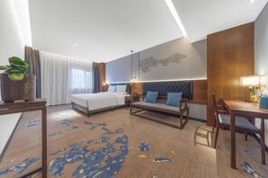 A modern hotel room with a bed, sofa, dining table, and a large window with curtains. - Madison Hotel Jinan Suncun Chunhui Road (Jinan)
