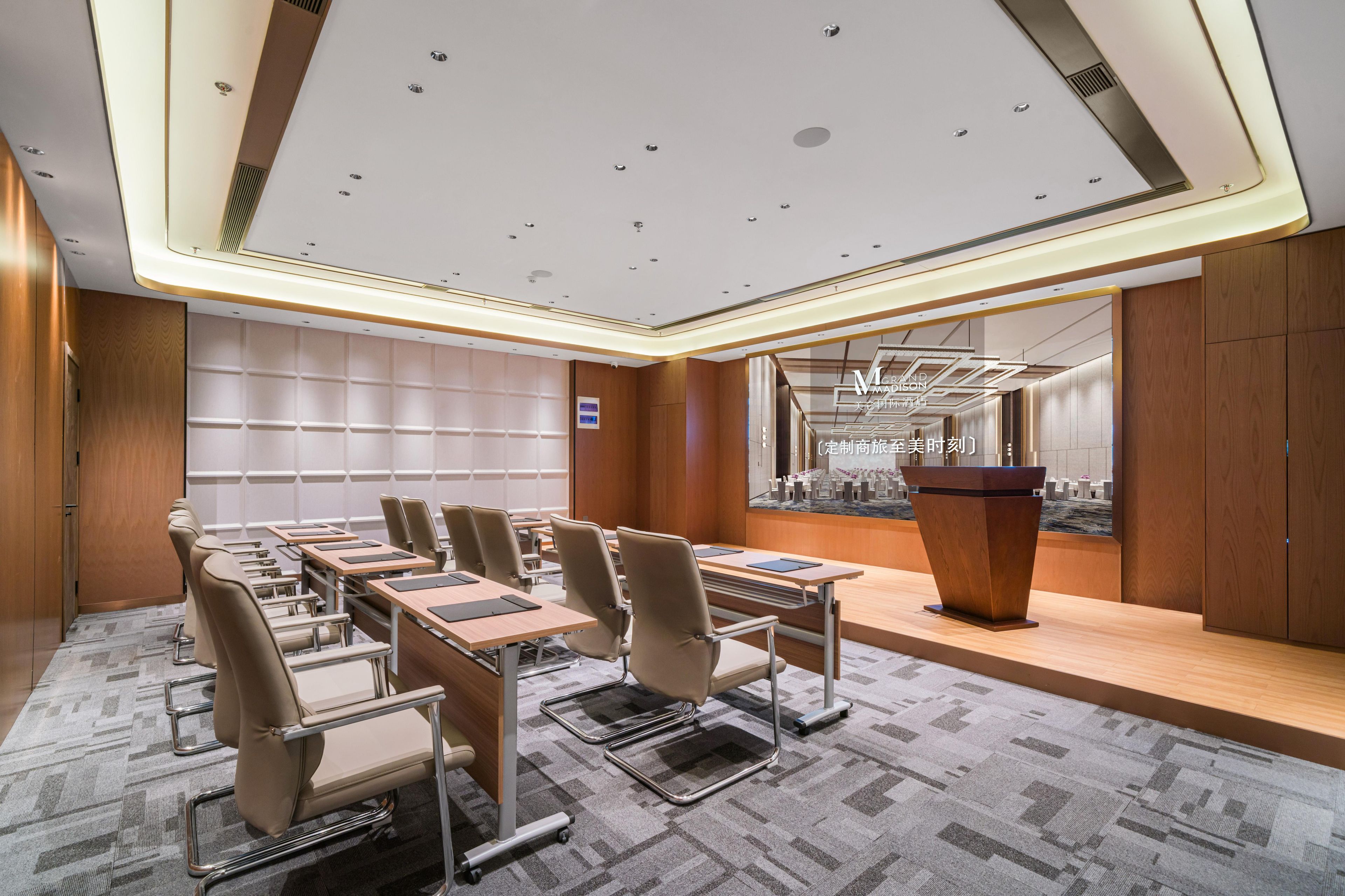 A conference room with a long table, chairs, a podium, and a cityscape view.