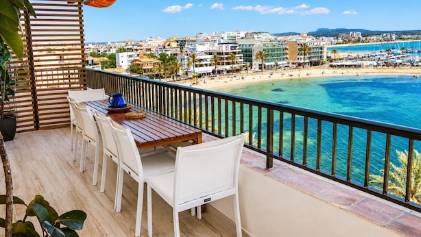 Un balcon avec vue sur la plage et sur le paysage urbain.