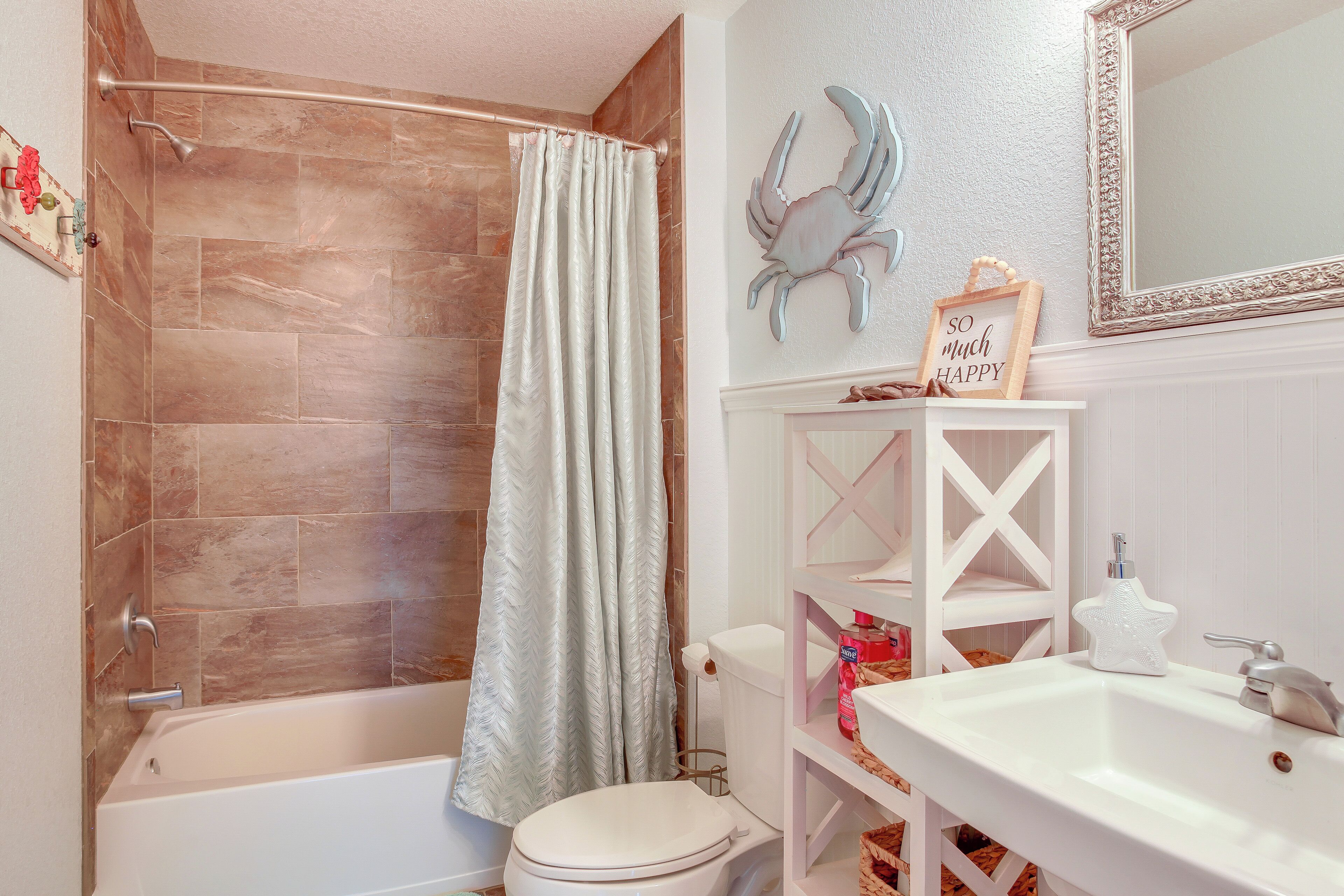 A bathroom with a bathtub, toilet, and sink.