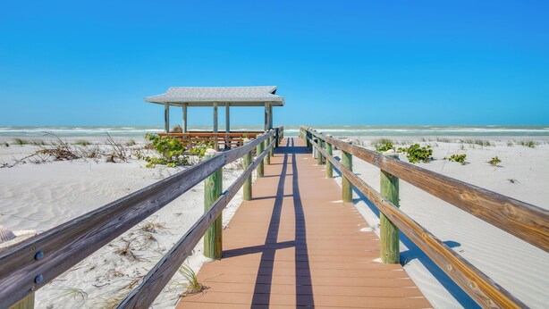 A wooden boardwalk leading to a beach pavilion with a clear view of the ocean. - Little Gasparilla Island Escape on Private Island! (Placida)