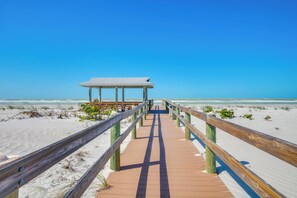 A wooden boardwalk leading to a beach pavilion with a clear view of the ocean. - Little Gasparilla Island Escape on Private Island! (Placida)