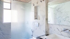 A modern bathroom with a marble sink, a glass shower enclosure, and a wooden ceiling. - Chirag Haveli Retreat (Manali)