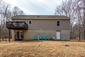 A two-story house with a balcony, a front door, and a garage. - My Blue Heaven | Game Area | 4 BDR | Pet Friendly (Albrightsville)