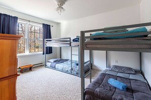 A bunk bed room with a window, a wooden bench, and a ceiling fan. - My Blue Heaven | Game Area | 4 BDR | Pet Friendly (Albrightsville)