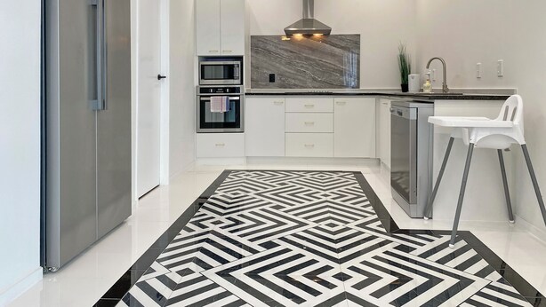 A modern kitchen with a stainless steel refrigerator, built-in oven, microwave, and dishwasher. - 6mins to airport. Large Family House. (Auckland)