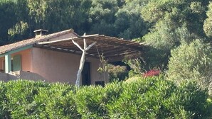 A rustic house with a tiled roof, surrounded by dense greenery and hills in the background. - Seaside villa, Gulf of LAVA, Appietto, South Corsica (Appietto)