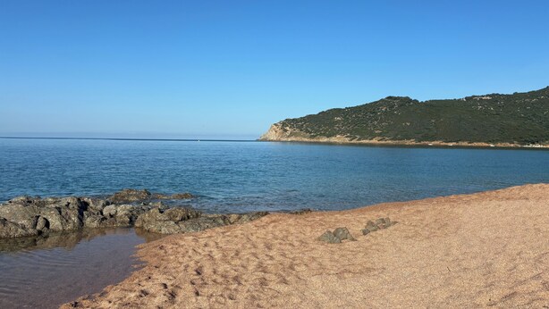 A beach with clear blue water, a rocky shoreline, and a hill with sparse vegetation in the background. - Seaside villa, Gulf of LAVA, Appietto, South Corsica (Appietto)