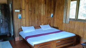 A wooden room with a bed, a bench, and a window. - Jungle Mount Adventures (Madikeri)