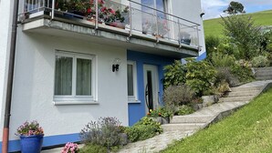 A two-story building with a balcony, a door, and a window. - Waibel Apartment, 60 sqm, 1 Bedroom, Terrace, Sleeps up to 3 Guests (Überlingen)