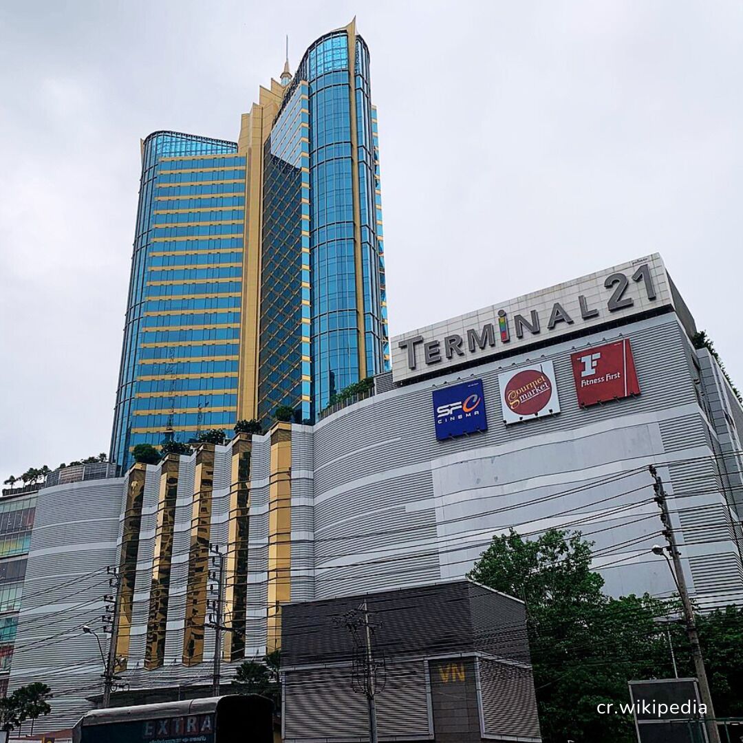 A building with a sign reading "TERMINAL 21" and multiple commercial signs including "SF Cinema" and "Fitness First".