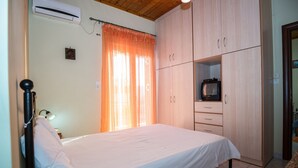 Ein Schlafzimmer mit Bett, Kleiderschrank und Fernseher.