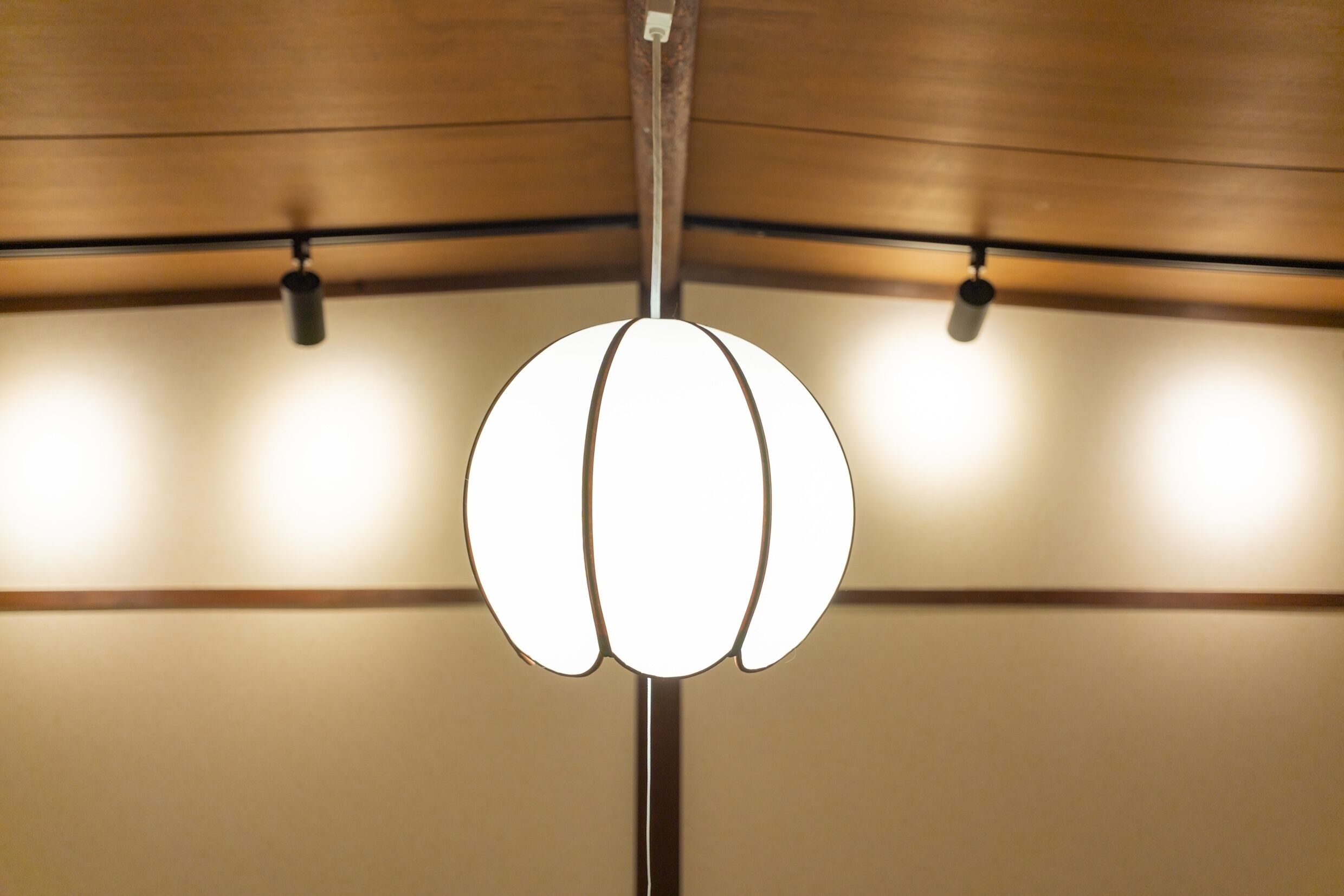 A ceiling with a central light fixture and two smaller lights on either side.