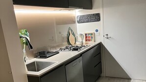 Eine moderne Küche mit Gasherd, Geschirrspüler und Kaffeemaschine.