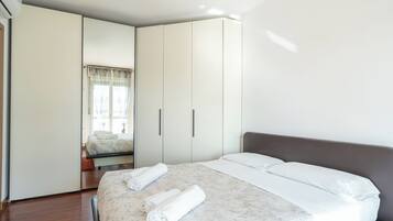 Una camera da letto moderna con un letto grande, un armadio e una finestra con tende.