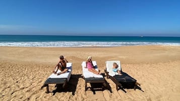 On the beach, sun loungers, beach towels