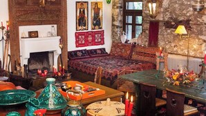 A cozy, rustic interior with a fireplace, wooden furniture, and traditional decor. - 260m2 Unique Mountain House in Lilea Parnasos (Delphi)