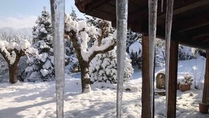 A snowy outdoor area with icicles hanging from a wooden structure. - 260m2 Unique Mountain House in Lilea Parnasos (Delphi)
