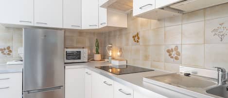 Fridge, microwave, cookware/dishes/utensils, dining tables