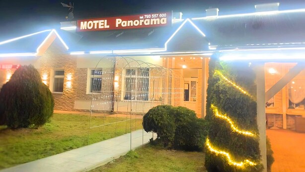 A motel named 'Motel Panorama' with a signboard, a pathway, and well-lit entrance. - Zajazd Panorama (Radymno)