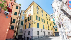 Una calle estrecha flanqueada por edificios, mostrando una mezcla de estilos arquitectónicos y un cielo despejado.
