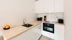 A modern kitchen with a sink, stove, and countertop.