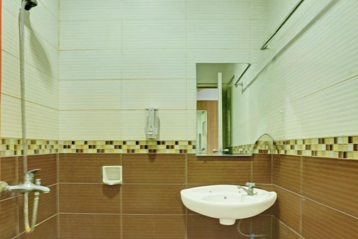 Une salle de bain avec un lavabo, un miroir et une douche.
