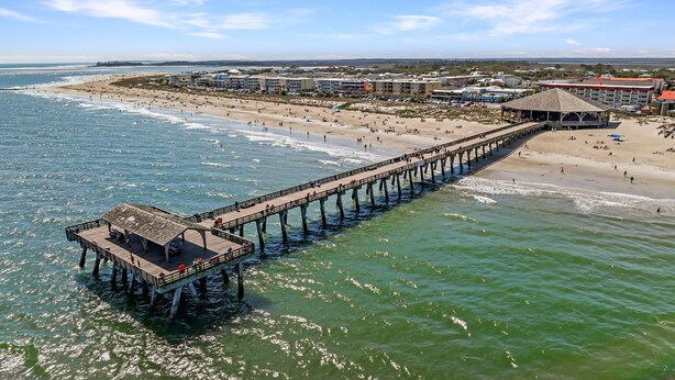 A pier extending into the ocean with a beach and buildings in the background. - Tybee Condo | Ocean View Porch + Walk to Fun (Tybee Island)