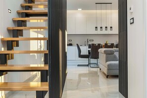 A modern interior with a staircase, a kitchen, and a seating area. - Villa Franka with pool near Medulin (Ližnjan)