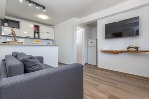 Apartment, Patio, Garden View | Living area | 32-inch flat-screen TV with cable channels