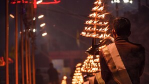 A person holding a traditional fire arrangement, likely used for ceremonial purposes. - Om Sai guest house (Varanasi)