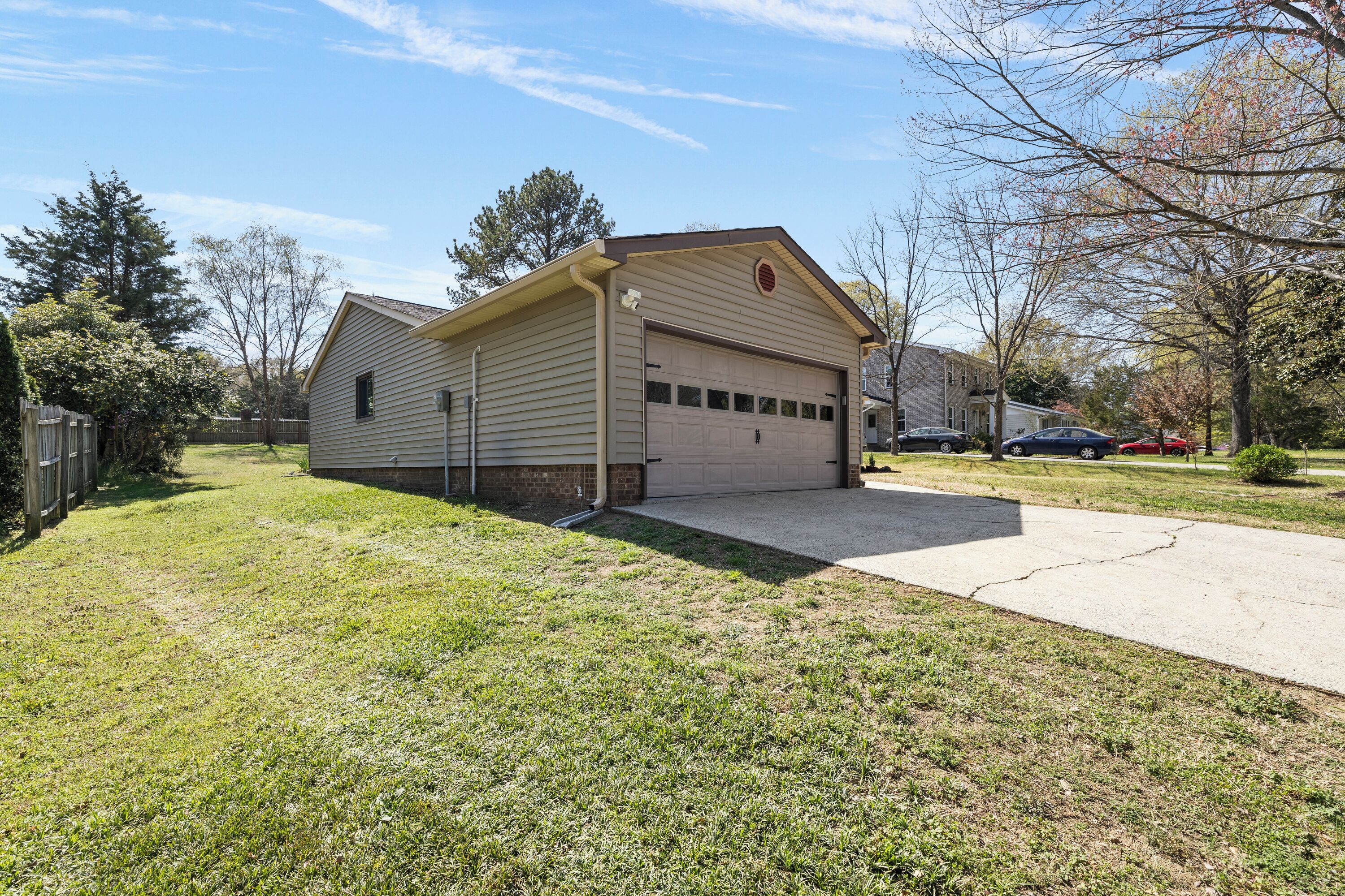 A single-story house with a garage, a front yard, and a driveway.