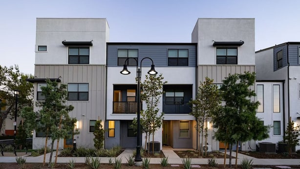 A modern multi-story residential building with a symmetrical facade, large windows, and a central entrance. - Modern Designer Stay Bright Chic Spacious (Ontario)