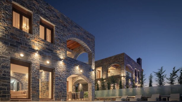 A modern building with stone walls and arched windows, a swimming pool, and outdoor seating. - Turtulli Castle Stone Villa 1 - Private Pool Oasis (Hersonissos)
