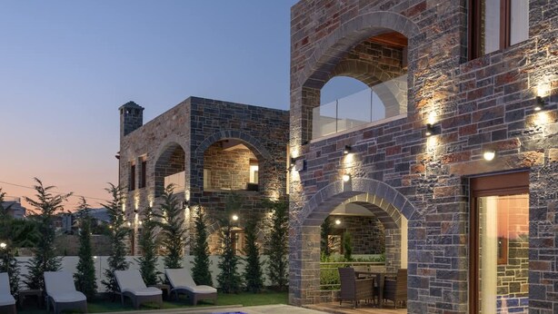 A modern house with a swimming pool, stone walls, and outdoor seating. - Turtulli Castle Stone Villa 2 - Private Pool Oasis (Hersonissos)